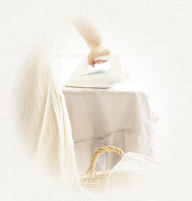 Woman ironing hospital bed sheet.